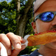 Man biting into corn dog